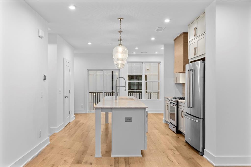201 New Street, Unit 1204 Decatur, GA 30030 - Photo 9 of 26 a kitchen with stainless steel appliances granite countertop a refrigerator oven a sink and dishwasher
