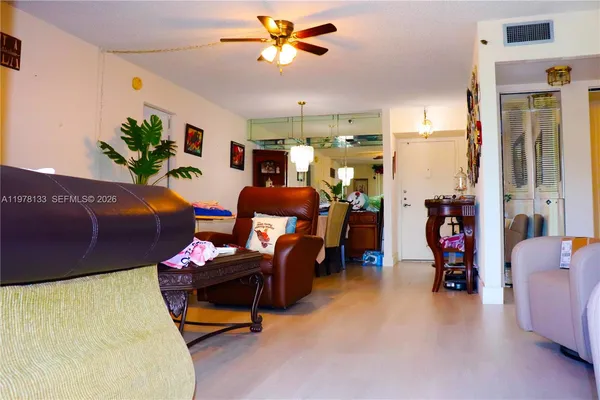 a living room with furniture a chandelier and a window