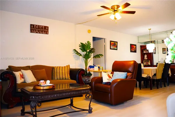 a living room with furniture and chandelier