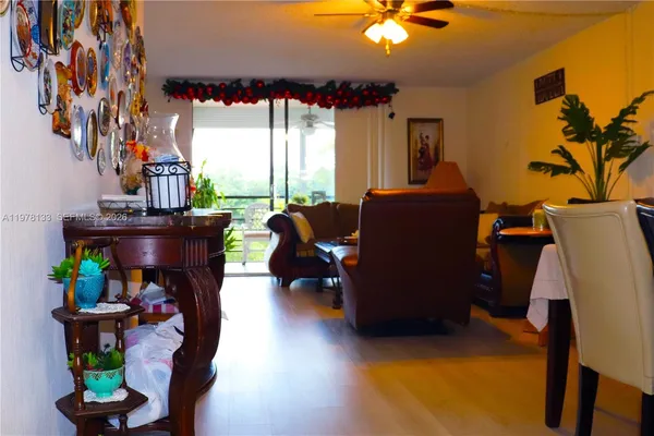 a living room with furniture a flat screen tv and a large window