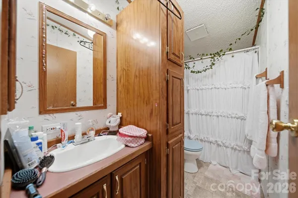 a bathroom with a sink vanity mirror and tub