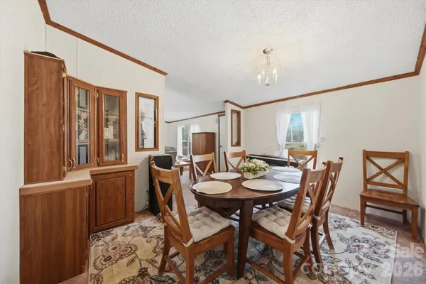 a view of a dining room with furniture and window