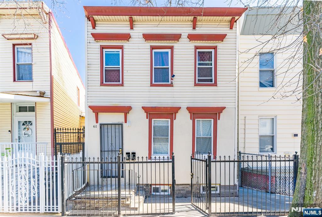 61 Cutler Street Newark, NJ 07104 - Photo 1 of 22 a view of a brick house with large windows