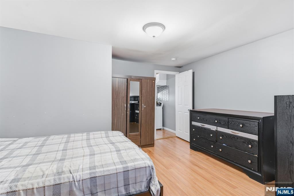 61 Cutler Street Newark, NJ 07104 - Photo 17 of 22 a bedroom with a bed and a dresser