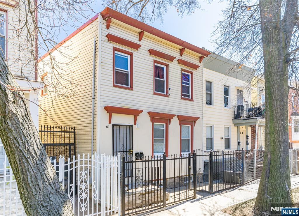 61 Cutler Street Newark, NJ 07104 - Photo 18 of 22 a front view of a house with a iron gate