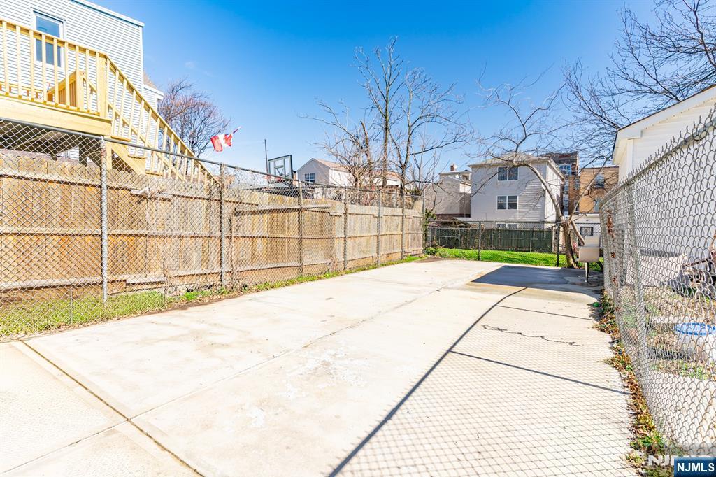 61 Cutler Street Newark, NJ 07104 - Photo 20 of 22 a view of a backyard with wooden fence