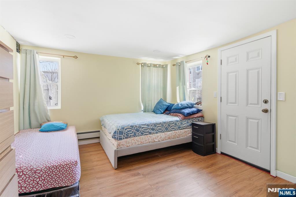 61 Cutler Street Newark, NJ 07104 - Photo 6 of 22 a bedroom with a bed and a window