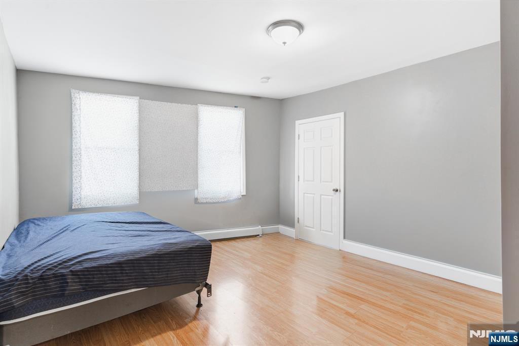 61 Cutler Street Newark, NJ 07104 - Photo 8 of 22 a bedroom with a bed and a window