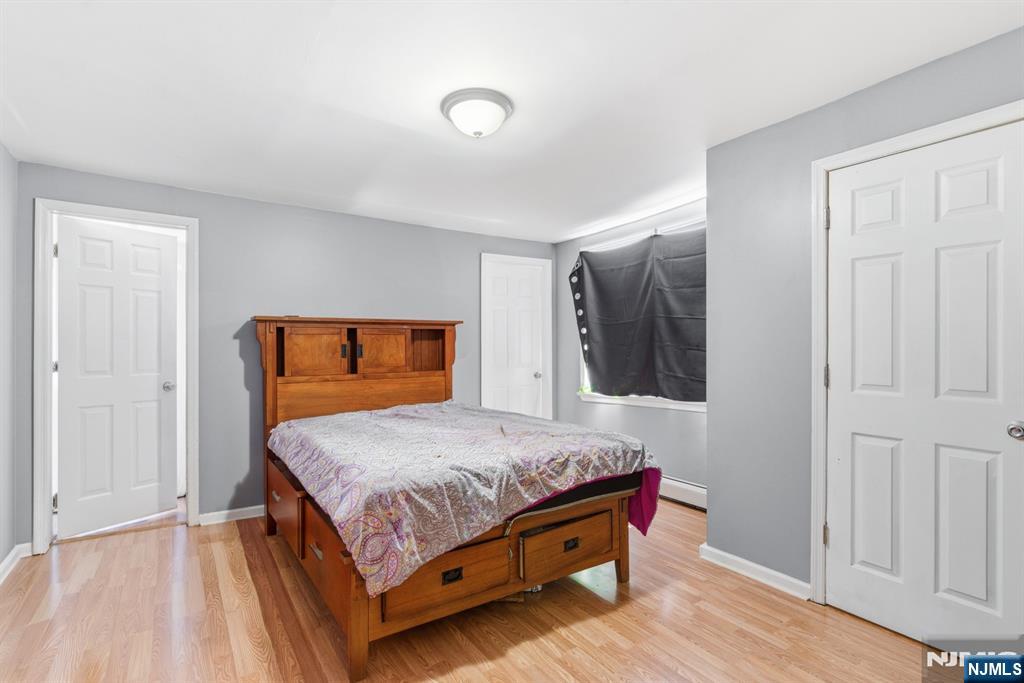 61 Cutler Street Newark, NJ 07104 - Photo 10 of 22 a bedroom with a bed and wooden floor