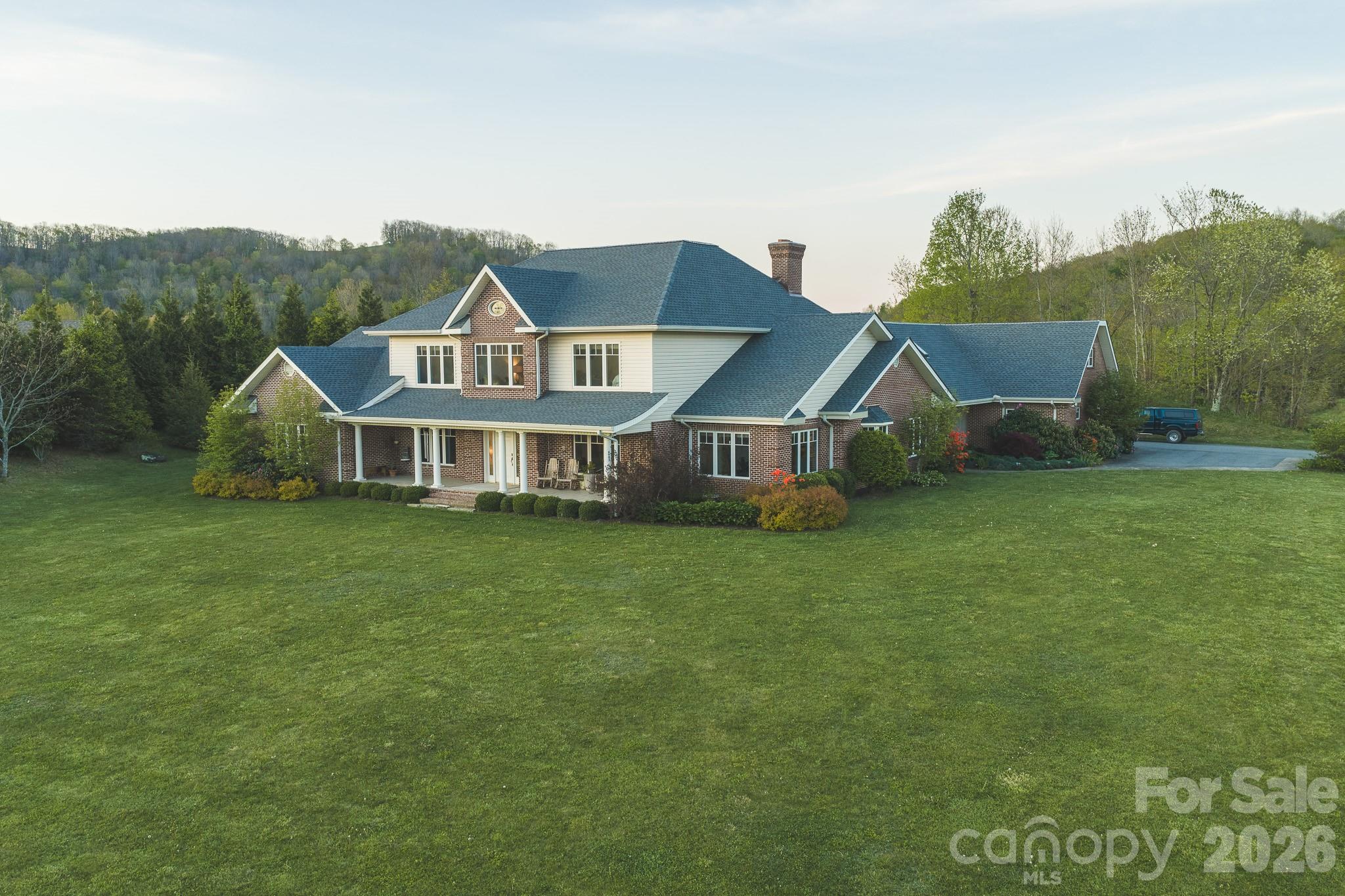 6985 Junaluska Road Boone, NC 28607 - Photo 2 of 35 a front view of a house with a garden