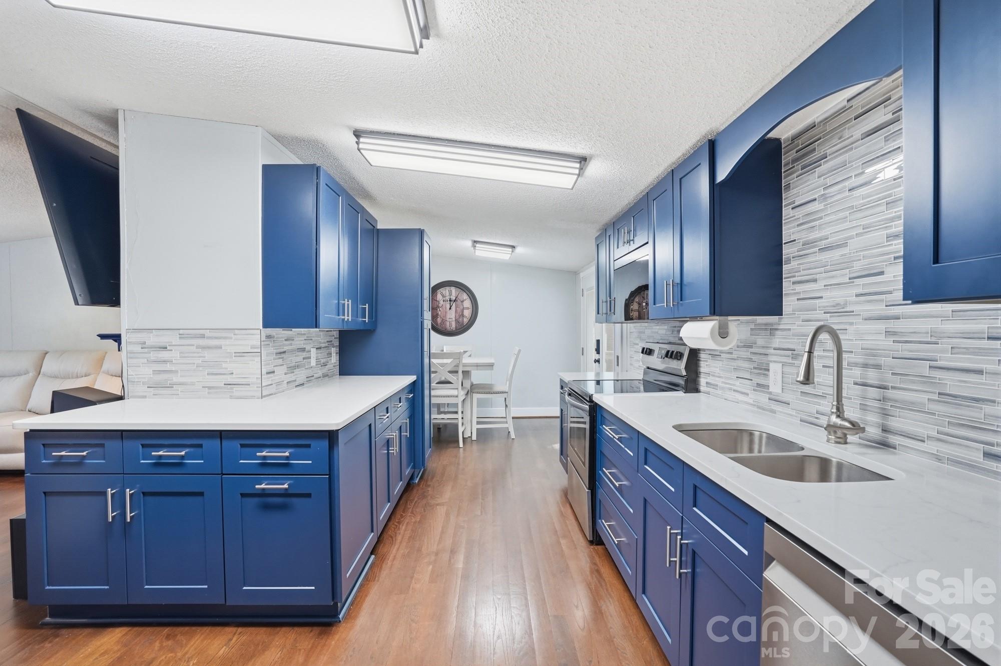 605 Ridgewood Court Mount Holly, NC 28120 - Photo 5 of 32 a kitchen with a sink and wooden cabinets