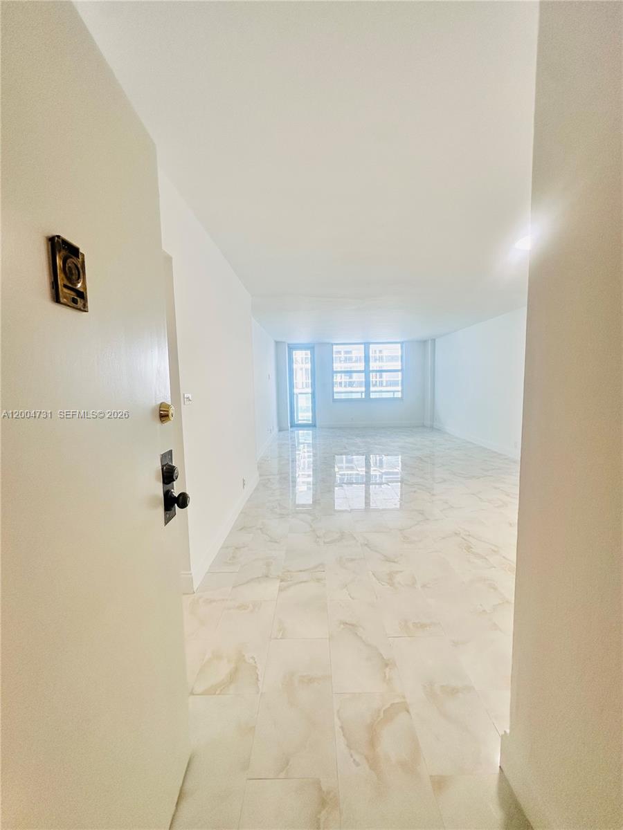 9511 Collins Avenue, Unit 1001 Surfside, FL 33154 - Photo 11 of 34 a view of an empty room with a window