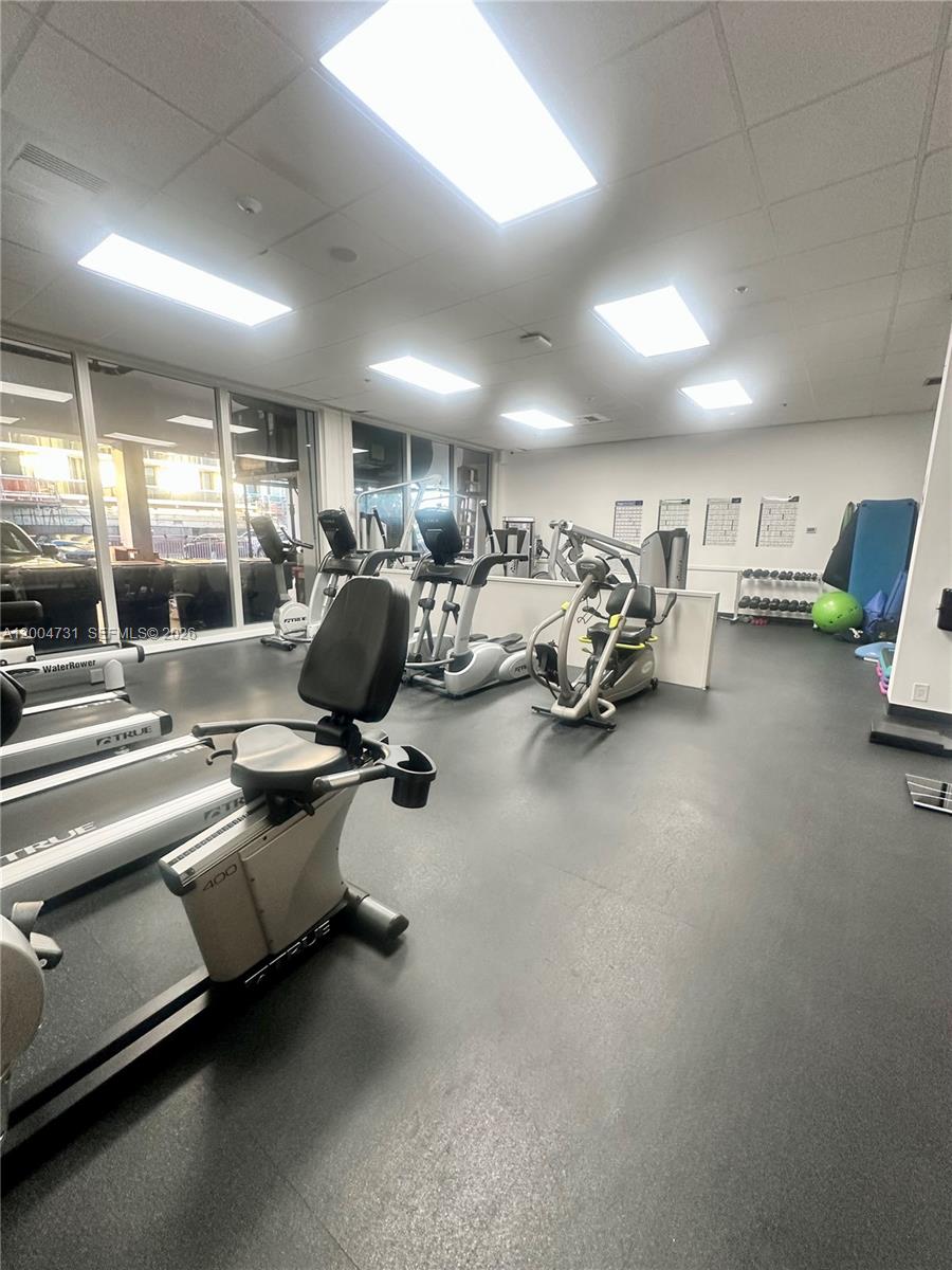 9511 Collins Avenue, Unit 1001 Surfside, FL 33154 - Photo 22 of 34 a view of a room with gym equipment