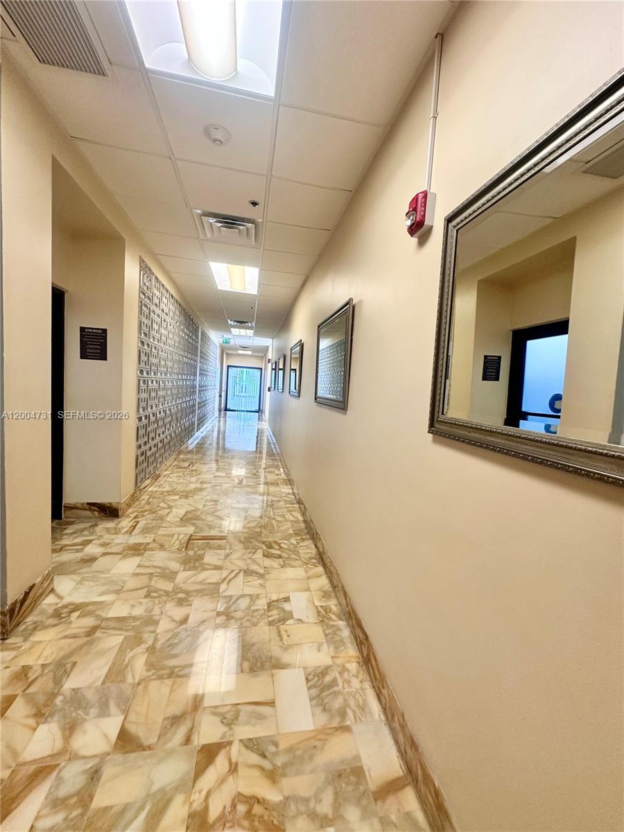 9511 Collins Avenue, Unit 1001 Surfside, FL 33154 - Photo 23 of 34 a view of a hallway with a large window