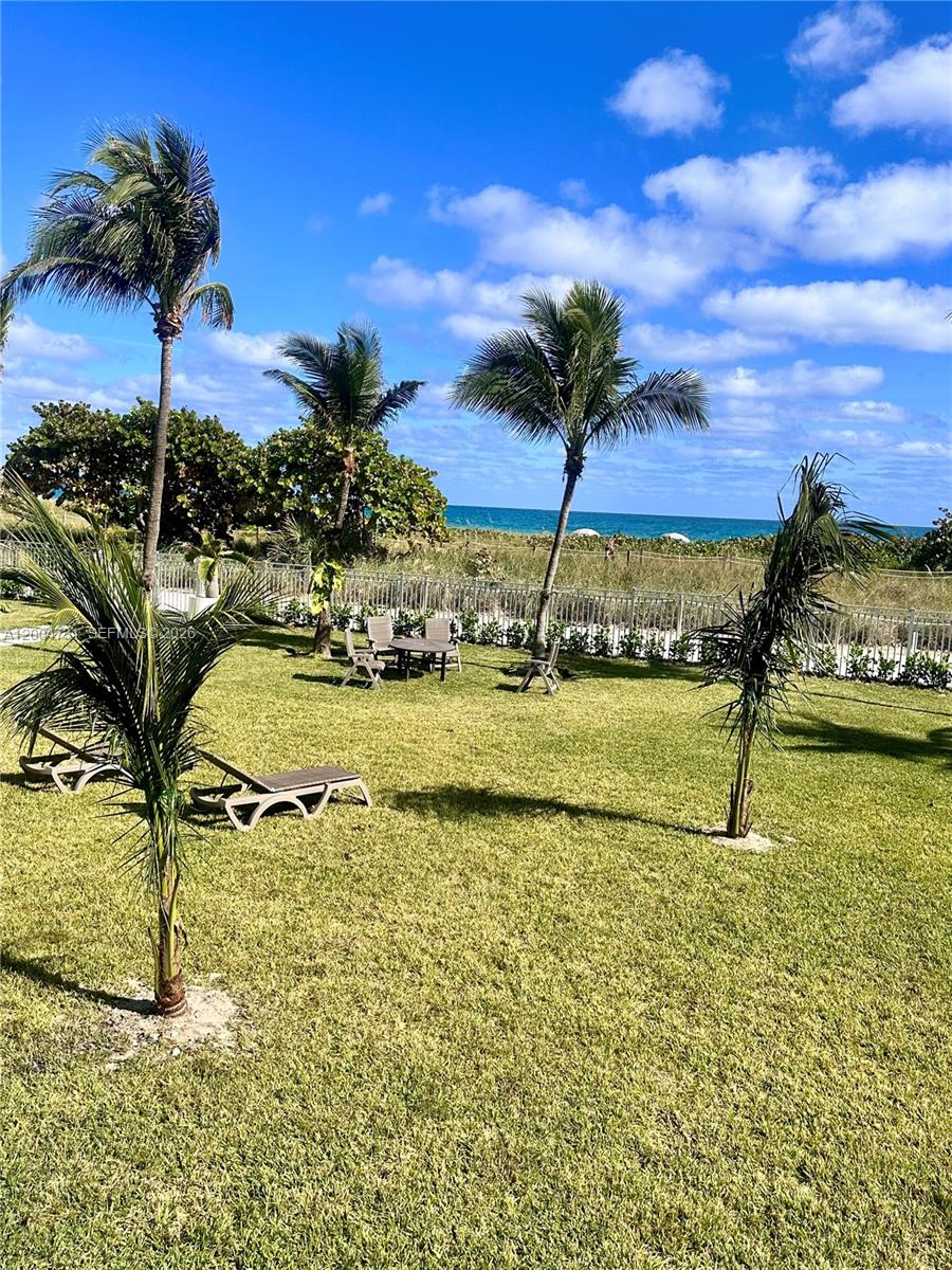 9511 Collins Avenue, Unit 1001 Surfside, FL 33154 - Photo 31 of 34 a view of swimming pool with a table and chairs