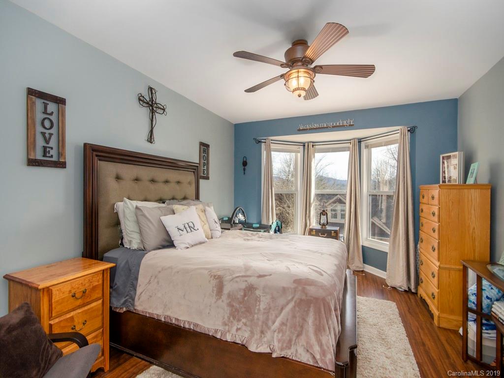 30 North Ridge Point, Unit T3 Sylva, NC 28779 - Photo 11 of 18 a bedroom with a large bed and a flat tv screen