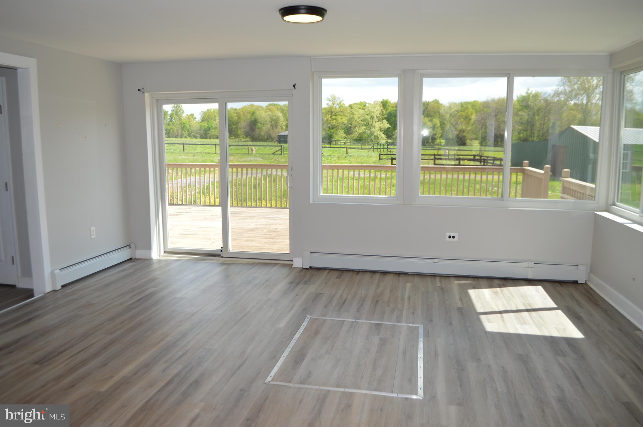 2051 Stover Road Taneytown, MD 21787 - Photo 17 of 44 an empty room with wooden floor and windows
