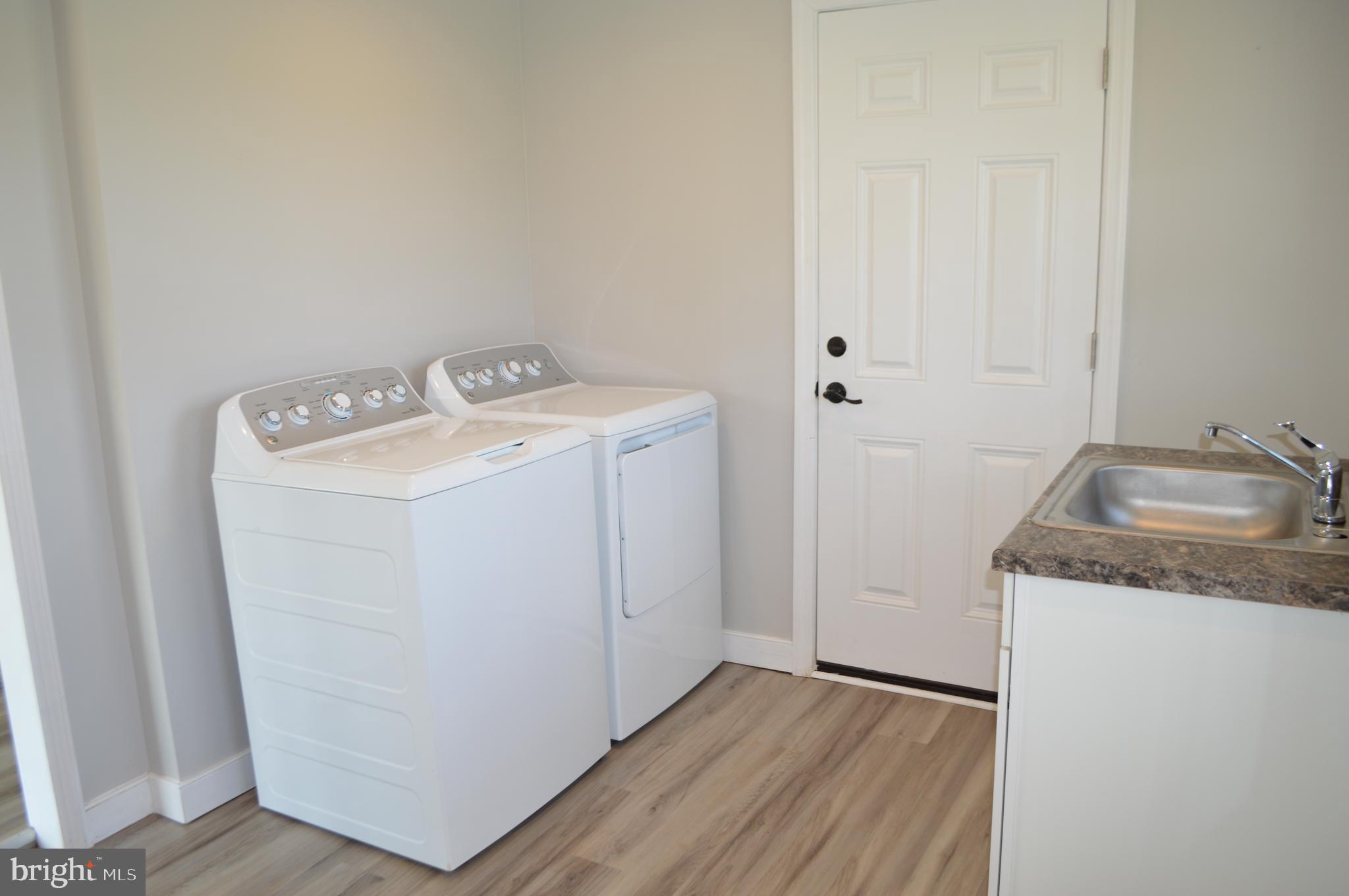 2051 Stover Road Taneytown, MD 21787 - Photo 19 of 44 a utility room with wooden floor washer and dryer