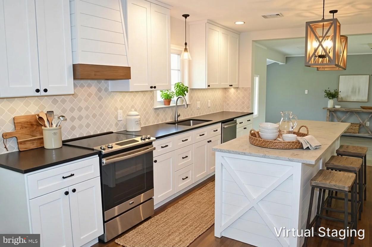 2051 Stover Road Taneytown, MD 21787 - Photo 22 of 44 a kitchen with granite countertop a sink a stove and cabinets