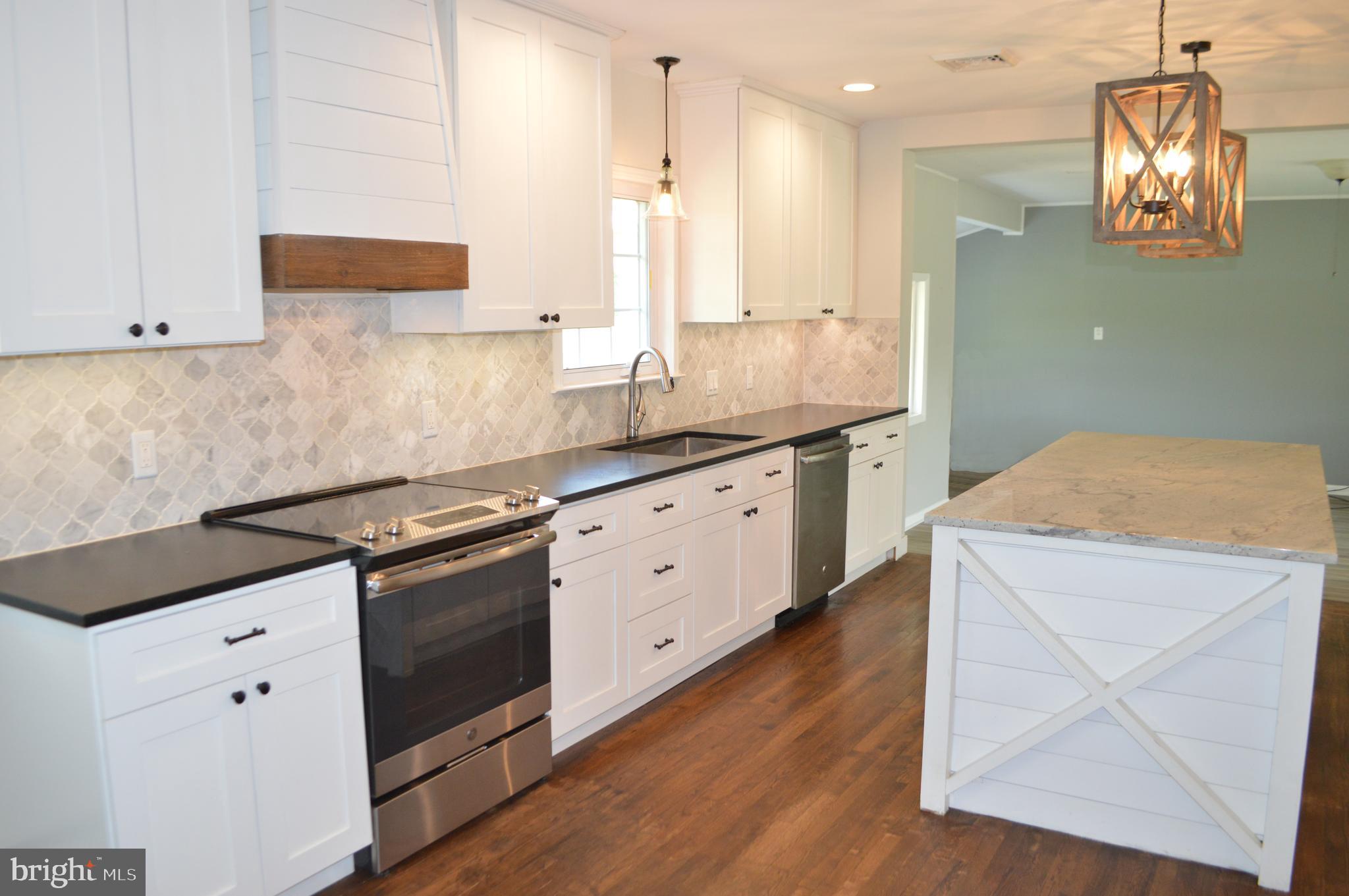 2051 Stover Road Taneytown, MD 21787 - Photo 23 of 44 a kitchen with a sink stove and cabinets