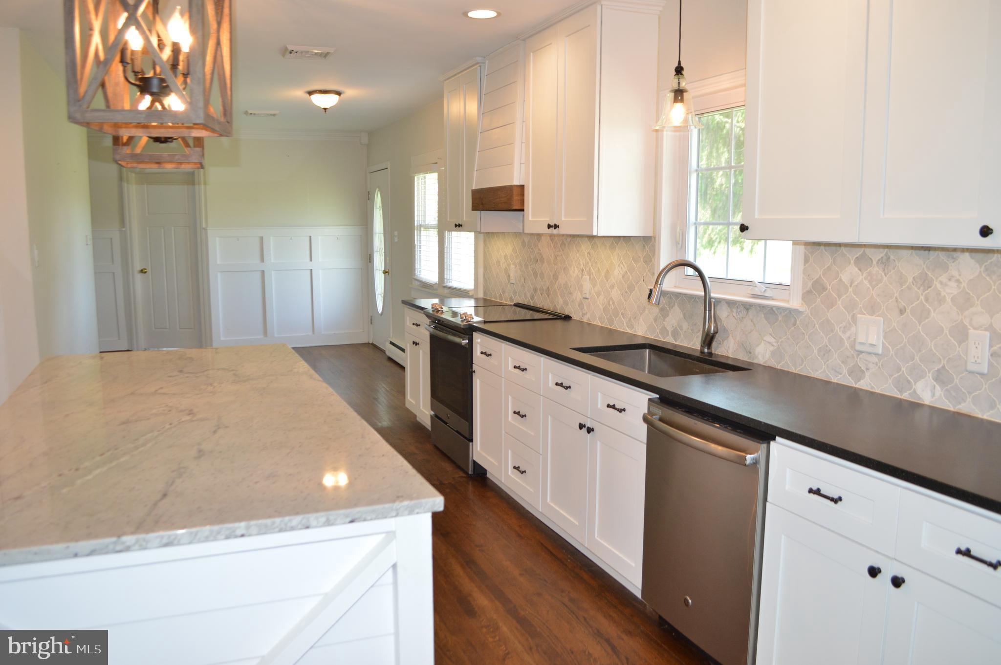 2051 Stover Road Taneytown, MD 21787 - Photo 26 of 44 a kitchen with stainless steel appliances a sink stove and cabinets