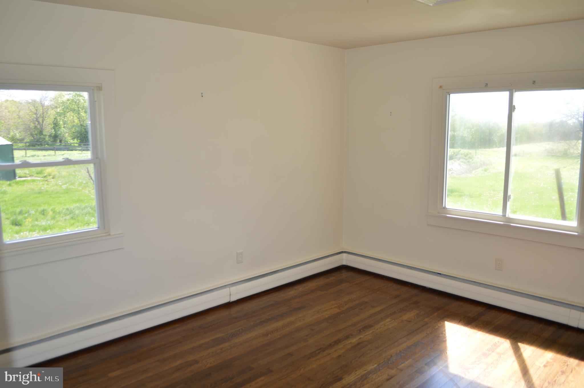 2051 Stover Road Taneytown, MD 21787 - Photo 36 of 44 an empty room with wooden floor and windows