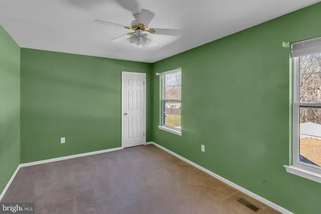a view of room with window and ceiling fan