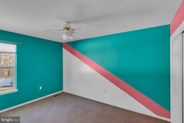 a view of a big room with windows and fan