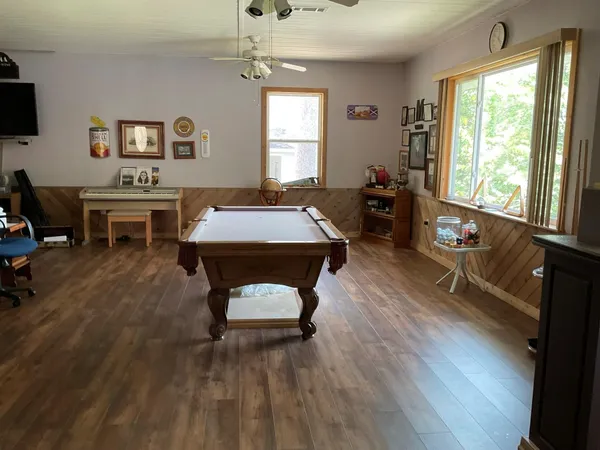 a living room with kitchen island furniture and a chandelier