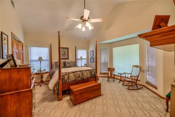 a bedroom with a bed a dresser and book shelf