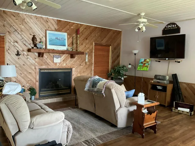 a living room with furniture and a wooden floor