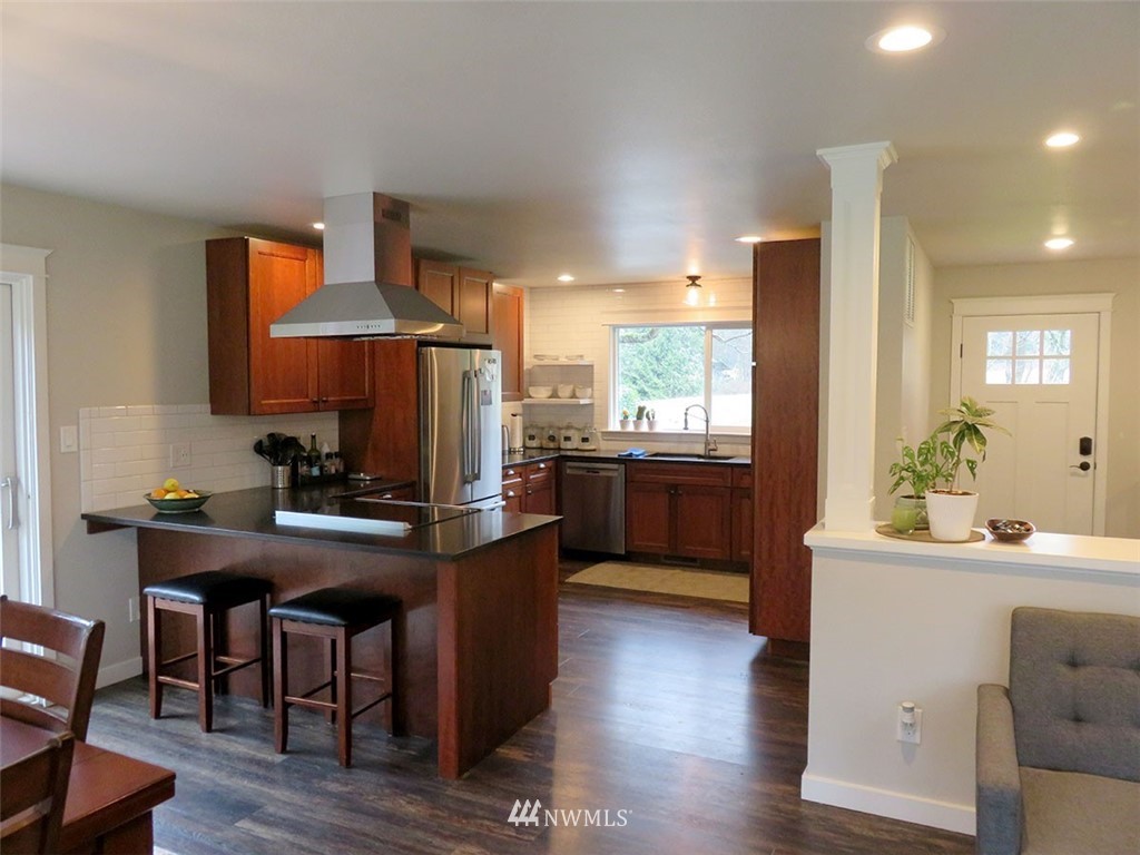 2664 Brown Road Ferndale, WA 98248 - Photo 4 of 16 a kitchen with granite countertop a sink cabinets and wooden floor