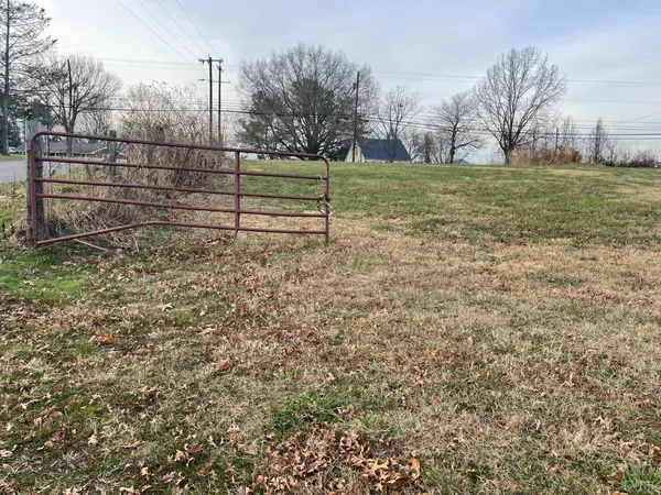 a view of a yard with wooden fence