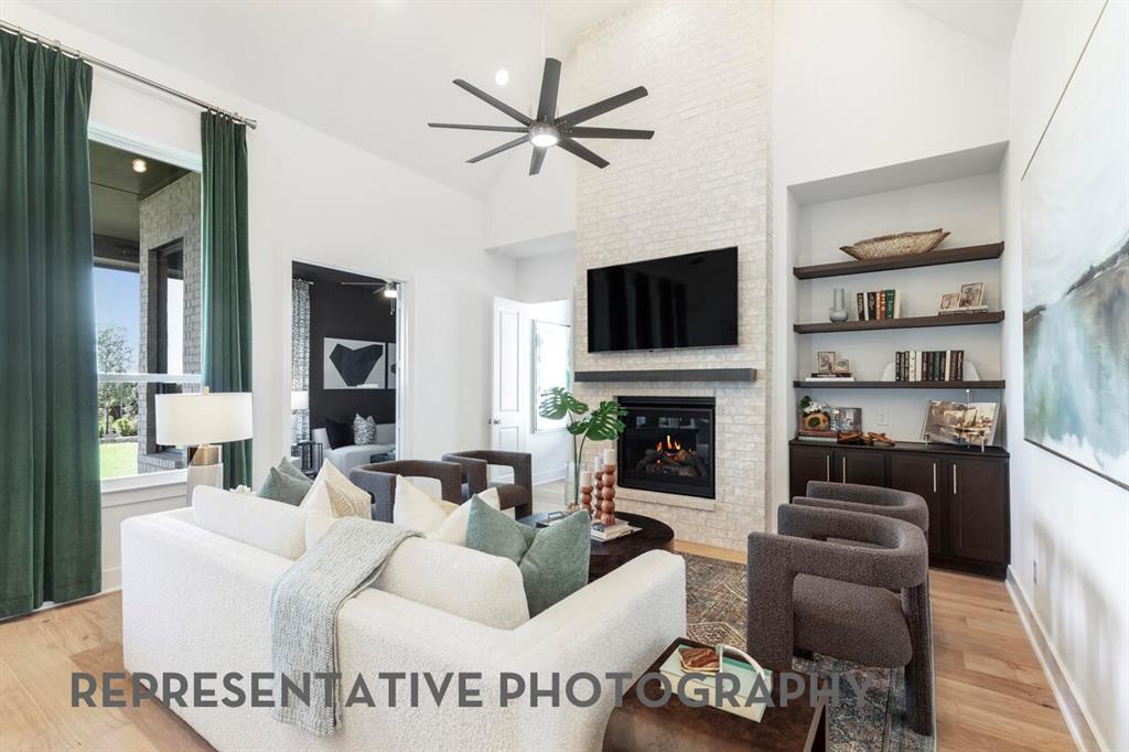 2907 Messenger Street Forney, TX 75126 - Photo 11 of 40 a living room with furniture a fireplace and a flat screen tv