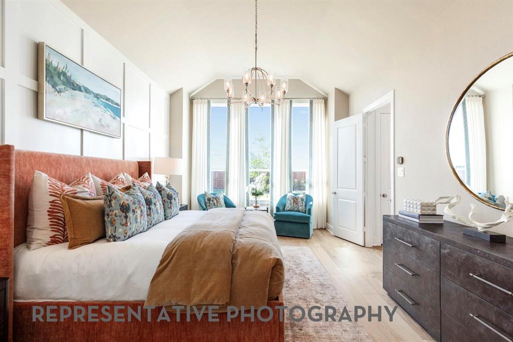 2907 Messenger Street Forney, TX 75126 - Photo 14 of 40 a spacious bedroom with a large bed and a chandelier