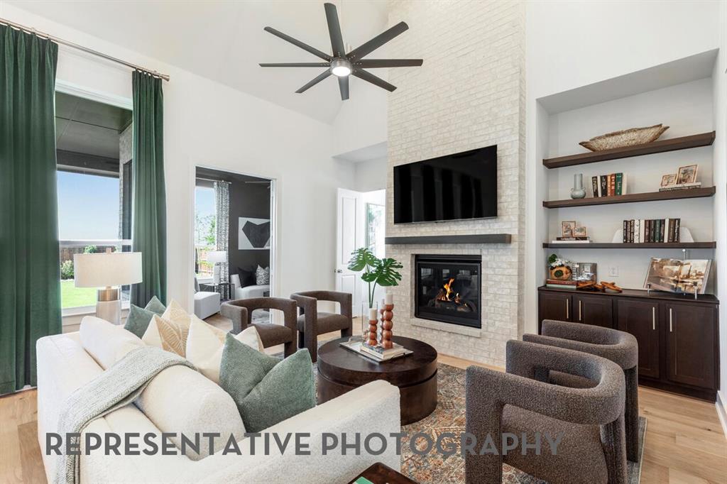 2907 Messenger Street Forney, TX 75126 - Photo 2 of 40 a living room with furniture a flat screen tv and a fireplace