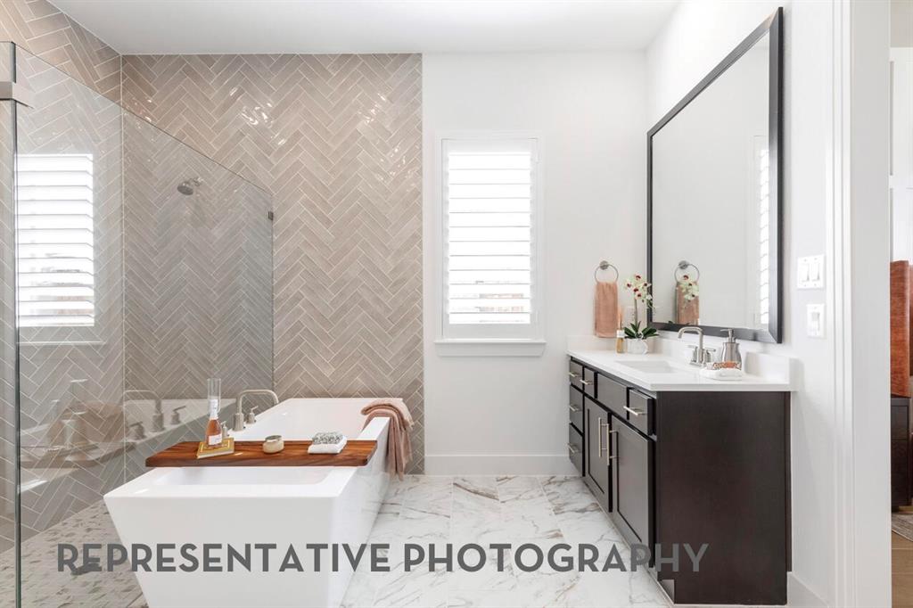 2907 Messenger Street Forney, TX 75126 - Photo 21 of 40 a bathroom with a sink mirror and a bathtub