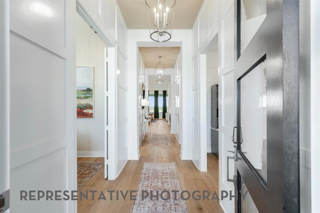 2907 Messenger Street Forney, TX 75126 - Photo 24 of 40 a view of a hallway with wooden floor and staircase