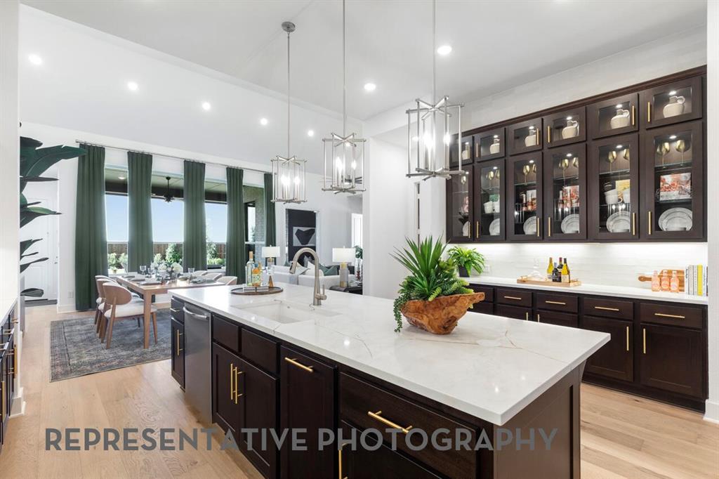 2907 Messenger Street Forney, TX 75126 - Photo 3 of 40 a kitchen with a sink a counter top space and living room view