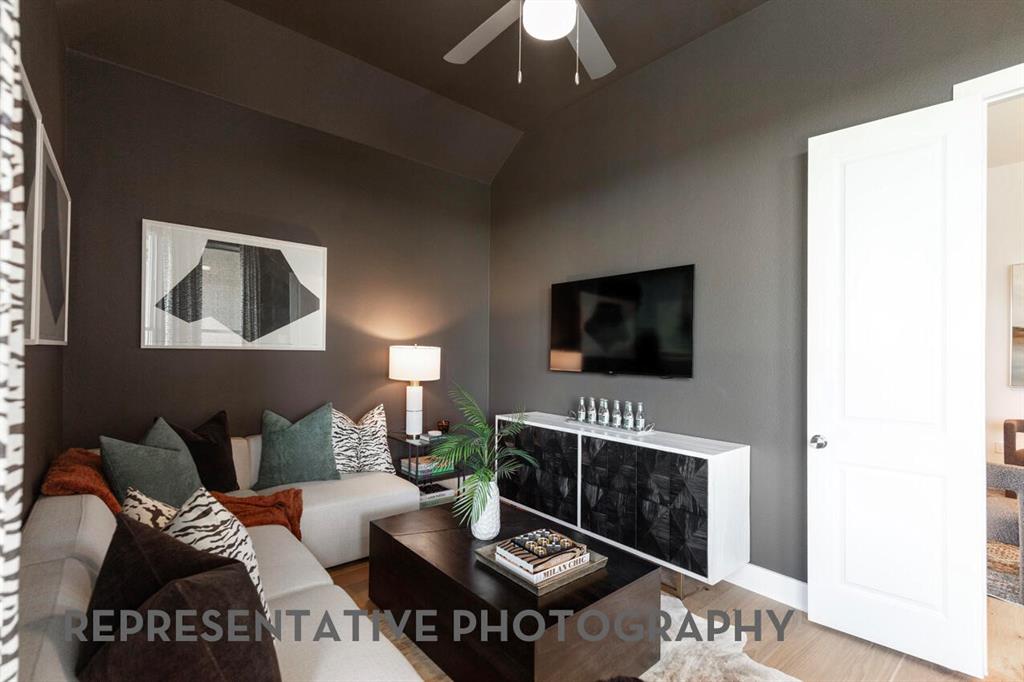 2907 Messenger Street Forney, TX 75126 - Photo 35 of 40 a living room with furniture a flat screen tv and a fireplace