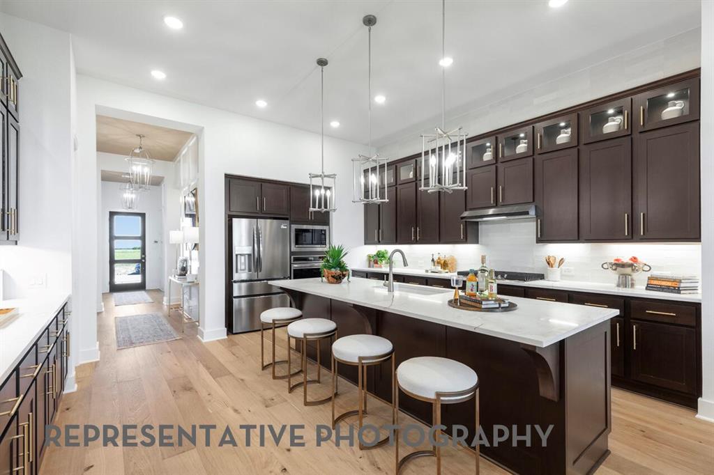 2907 Messenger Street Forney, TX 75126 - Photo 4 of 40 a kitchen with sink cabinets and refrigerator