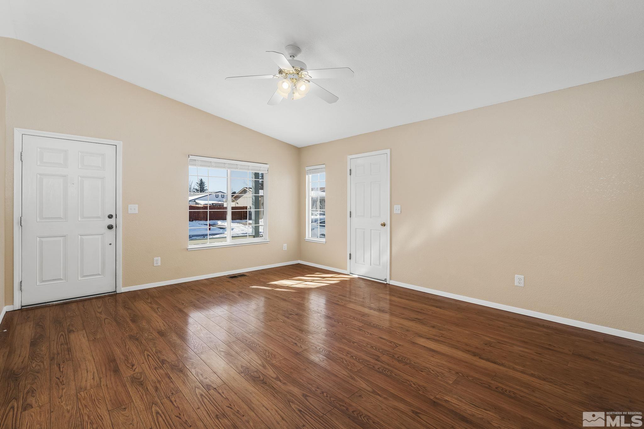 17765 Fortune Court Reno, NV 89508 - Photo 3 of 16 a view of an empty room with wooden floor and a window
