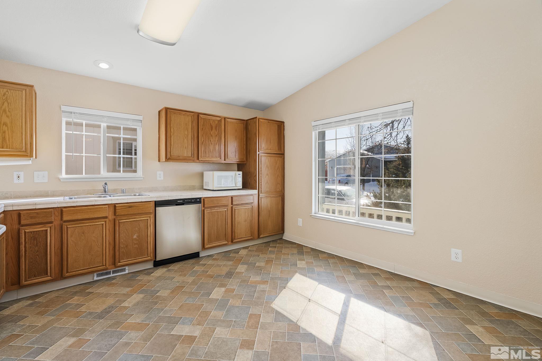 17765 Fortune Court Reno, NV 89508 - Photo 5 of 16 a kitchen with granite countertop a stove a sink and a granite counter tops