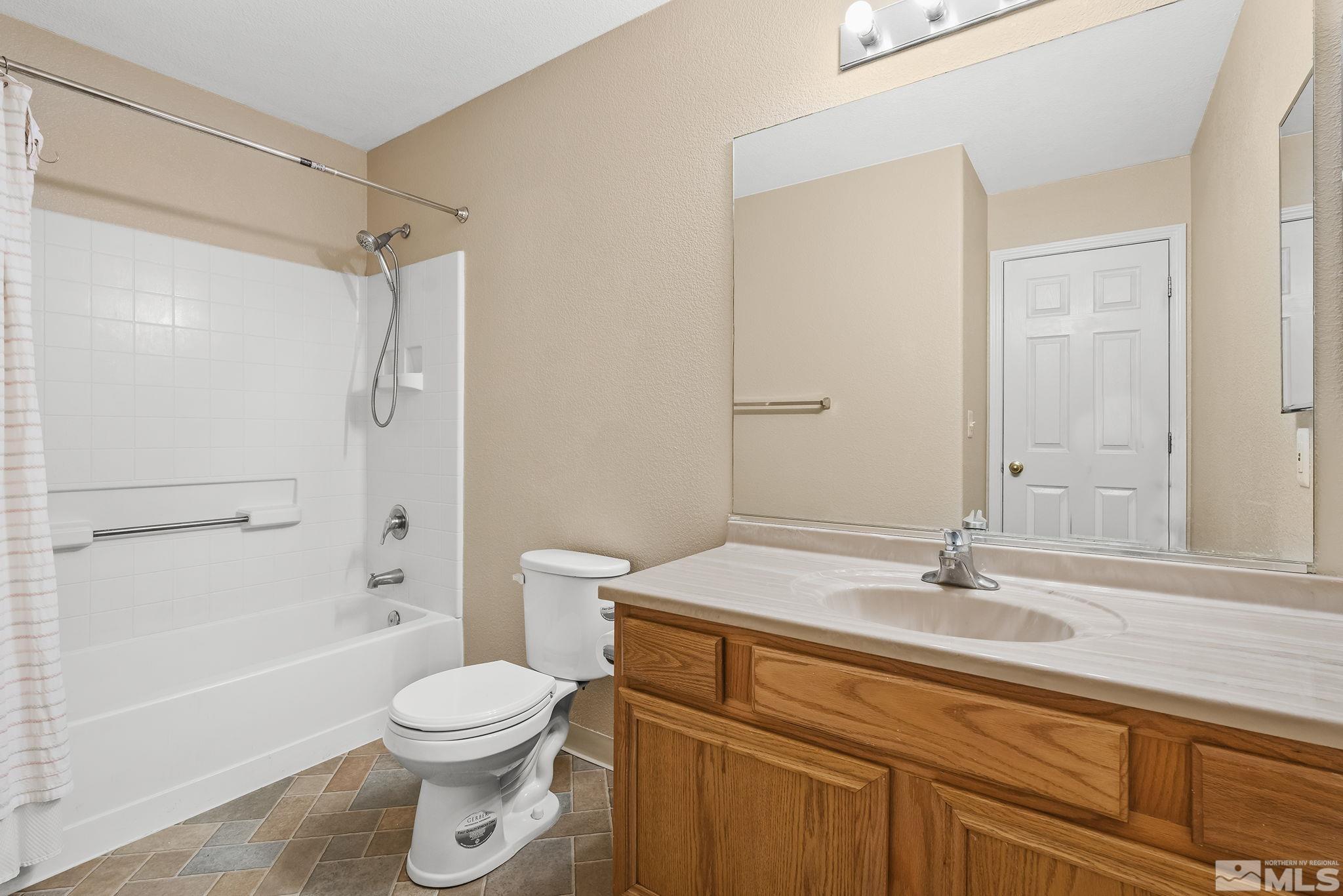 17765 Fortune Court Reno, NV 89508 - Photo 9 of 16 a bathroom with a sink a toilet and shower