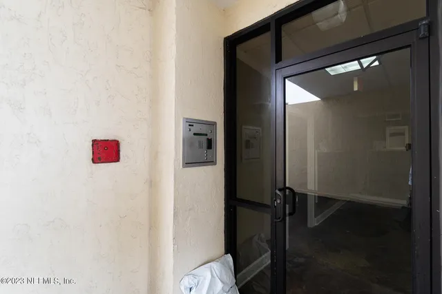 wooden floor with a black white wall