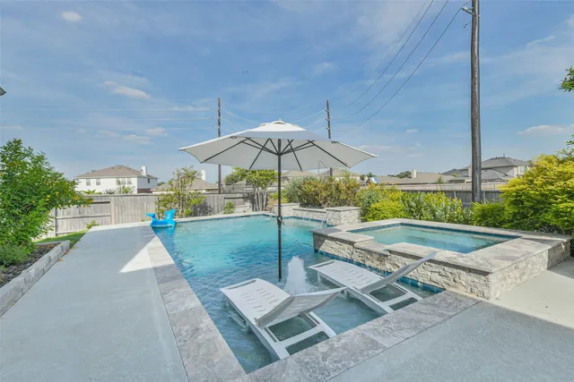 a view of a backyard with a garden and patio