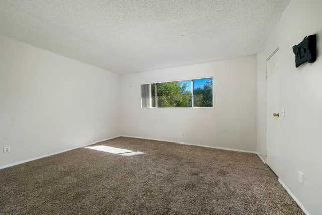 a view of a hallway with wooden shelves