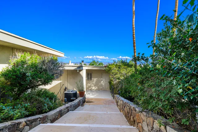 a view of a patio with chairs and tables