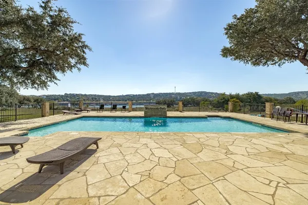 a view of swimming pool with outdoor space and lake view