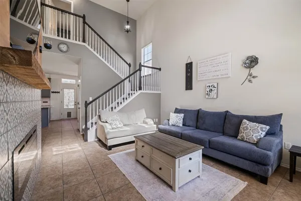 a living room with furniture and a chandelier
